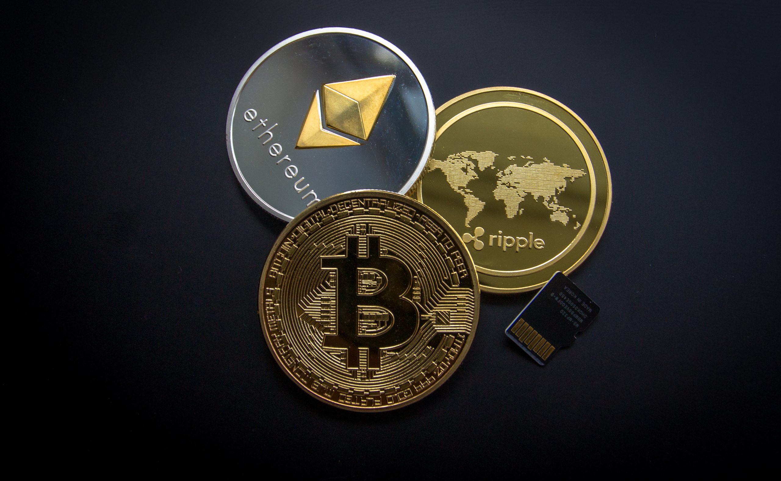 three coins with bitcoin ethereum and ripple xrp logos